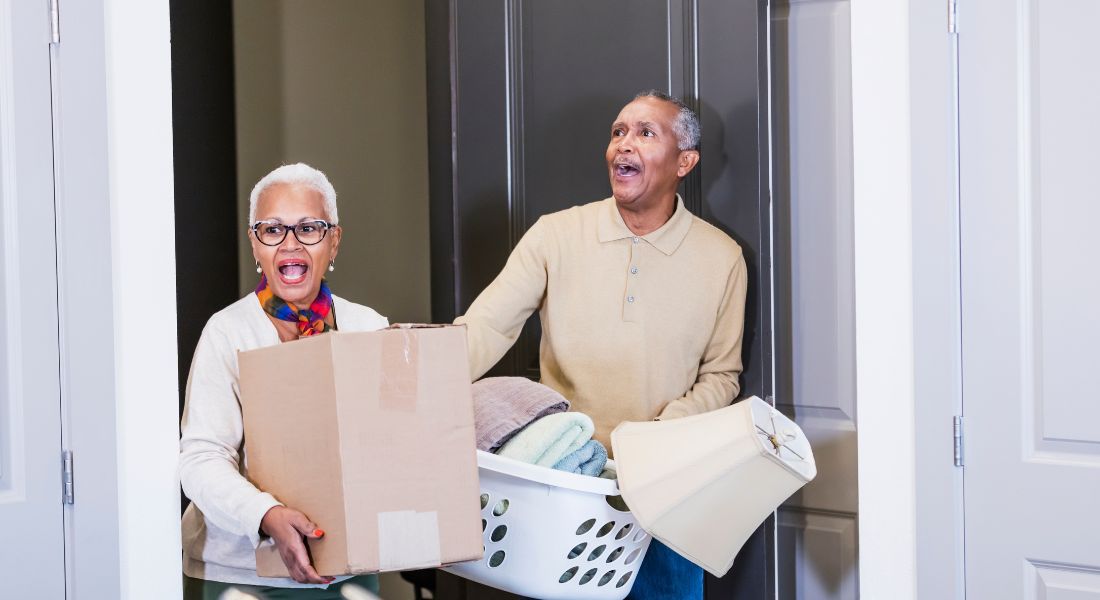 Woman and Man moving things out of a home.