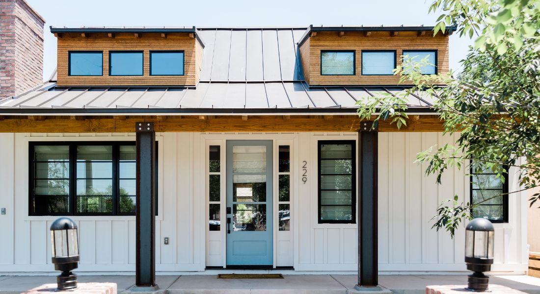 One Story Home, white with teal door.